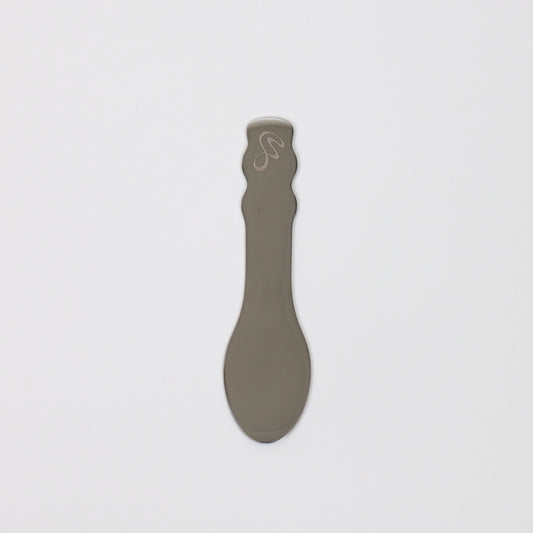 Body Butter Spatula in gray, designed for easy application of body butter products.