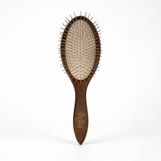 Awakening Hair Brush with a wooden handle and metal bristles for gentle detangling.