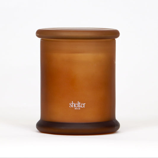 Vanilla Flame Candle in a frosted amber glass container.