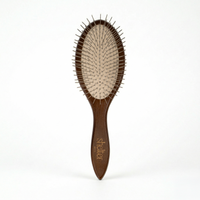 Awakening Hair Brush with a wooden handle and metal bristles for gentle detangling.