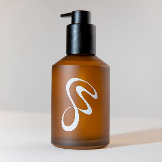 No.2 Vanilla Body Oil in an amber glass bottle with a black pump top.
