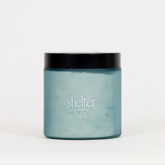 Coconut Milk Bath Melt in a frosted blue jar with a black lid, perfect for a soothing bath experience.