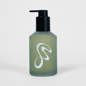 Light blue bottle with black pump on a light gray background