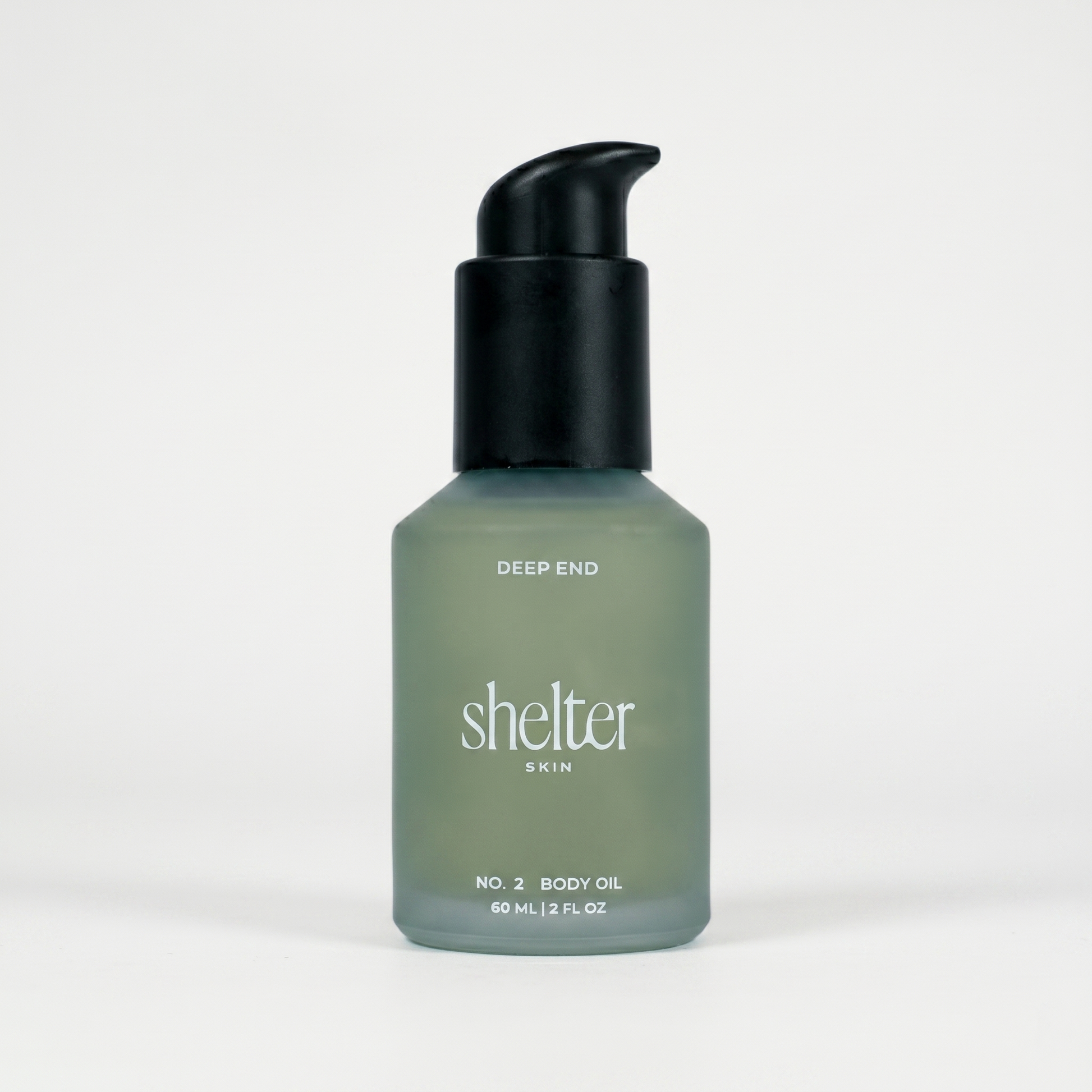 Bottle of 'Shelter Skin' body oil on a white background