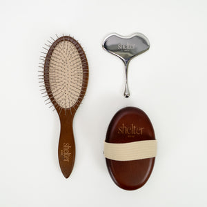 Tools Bundle featuring a wooden brush, metal facial tool, and a wooden massage tool.