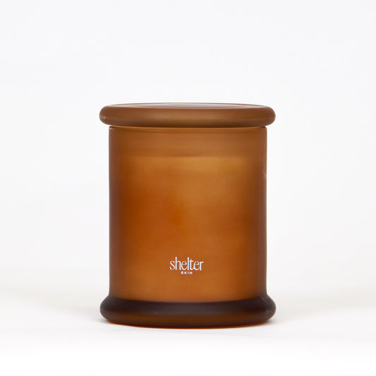 Vanilla Flame Candle in a frosted amber glass container.