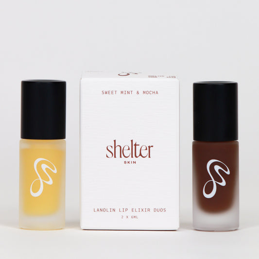 Mint & Mocha Lanolin Lip Elixir Duo in clear and brown bottles with white packaging.